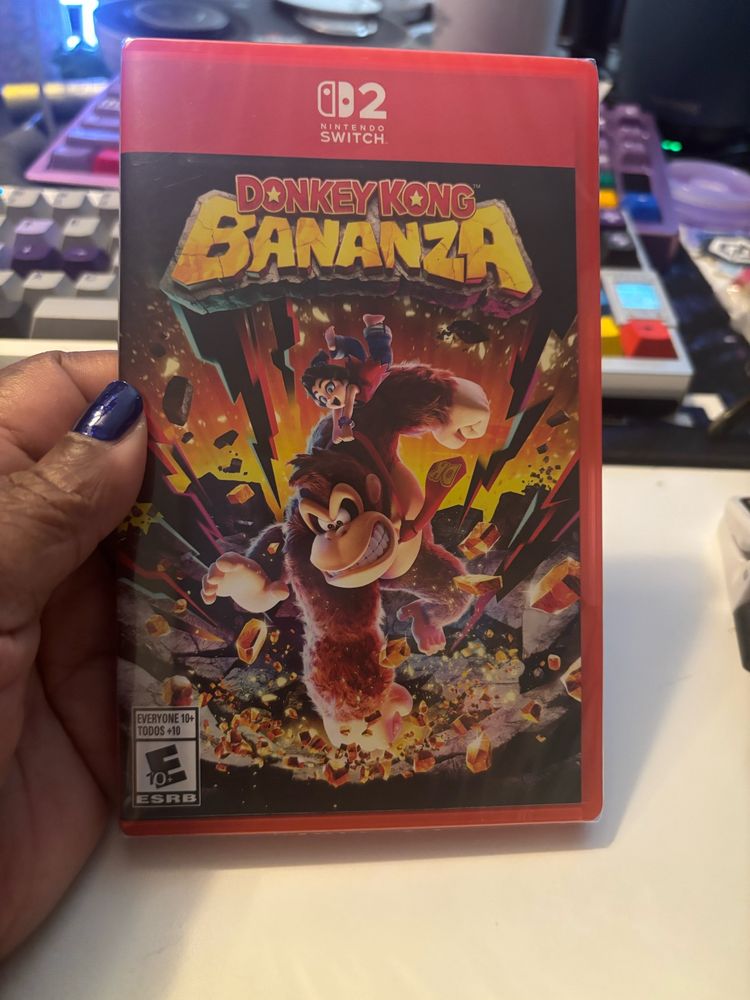 Sam holding a newly freed copy of Donkey Kong Bananza for the Switch 2. 