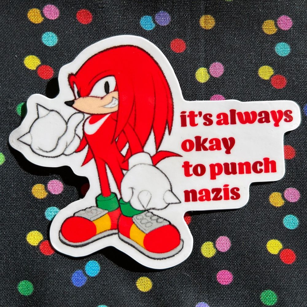 a photo of a sticker of Knuckles the Echidna, next to the text "it's always okay to punch nazis"
