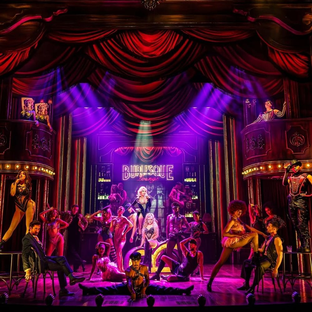 The cast of Burlesque in forgivingly low lighting. Burlesque at the Savoy Theatre, 2025.