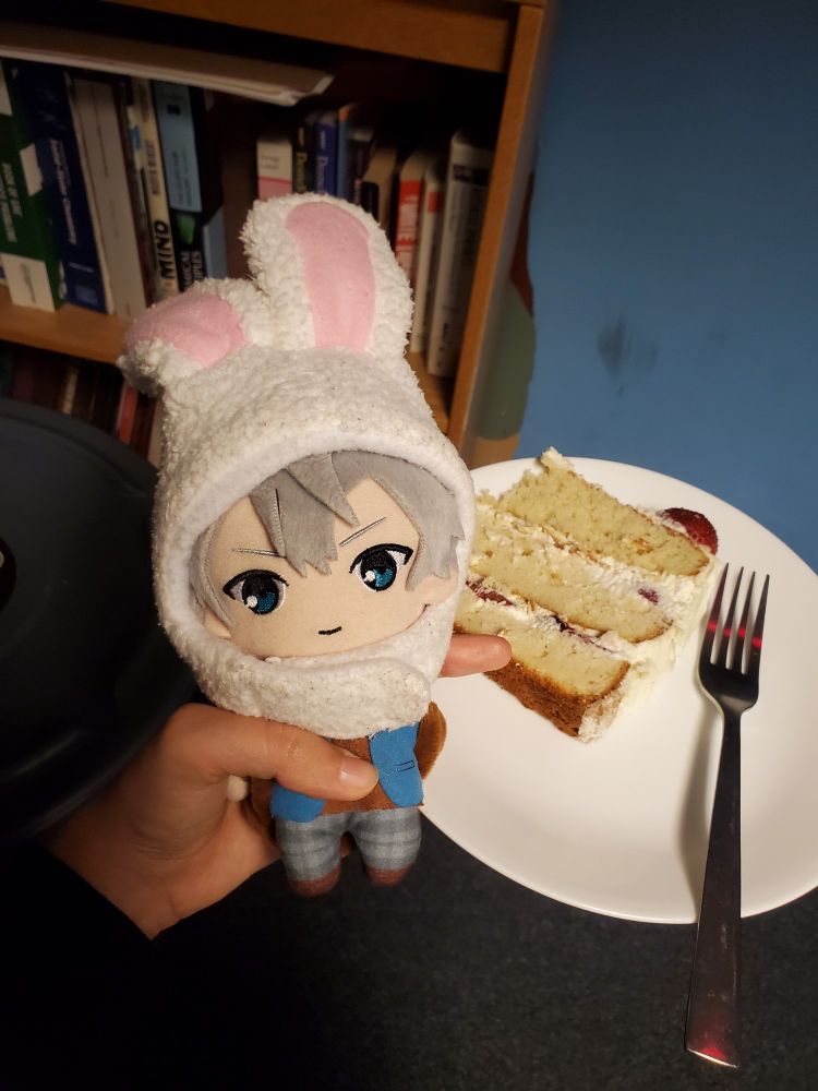 izumi sena plushie wearing bunny ears posed with a plate with a slice of cake on it