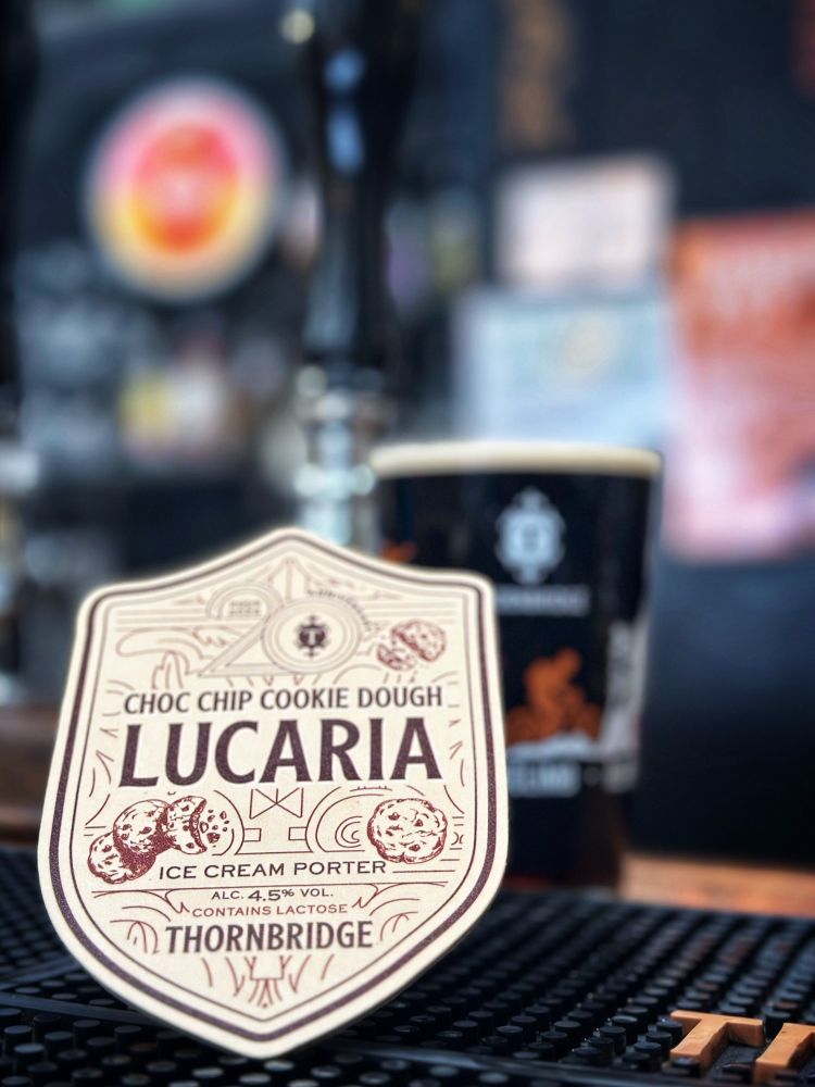 the choc chip cookie dough Lucaria pump clip next to a pint of this beer