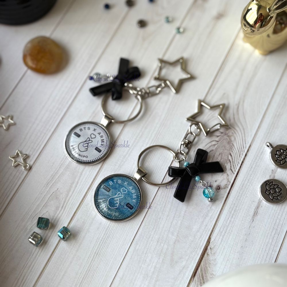 Handmades keychains by CloudLily. Printed artwork and designs in resin  sealed glass domes. Available at CloudLilySparkle.Etsy.com