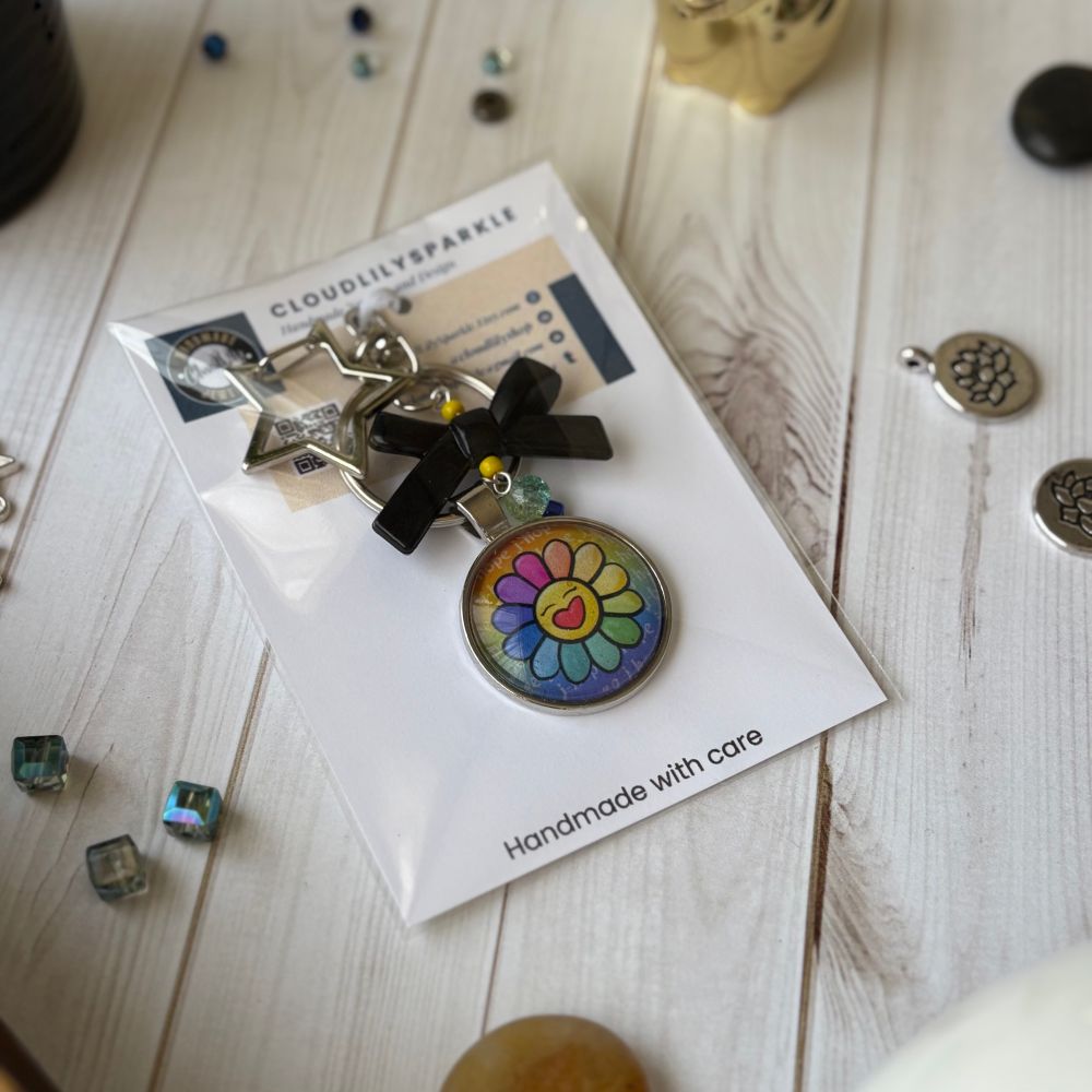 Handmades keychains by CloudLily. Printed artwork and designs in resin  sealed glass domes. Available at CloudLilySparkle.Etsy.com
