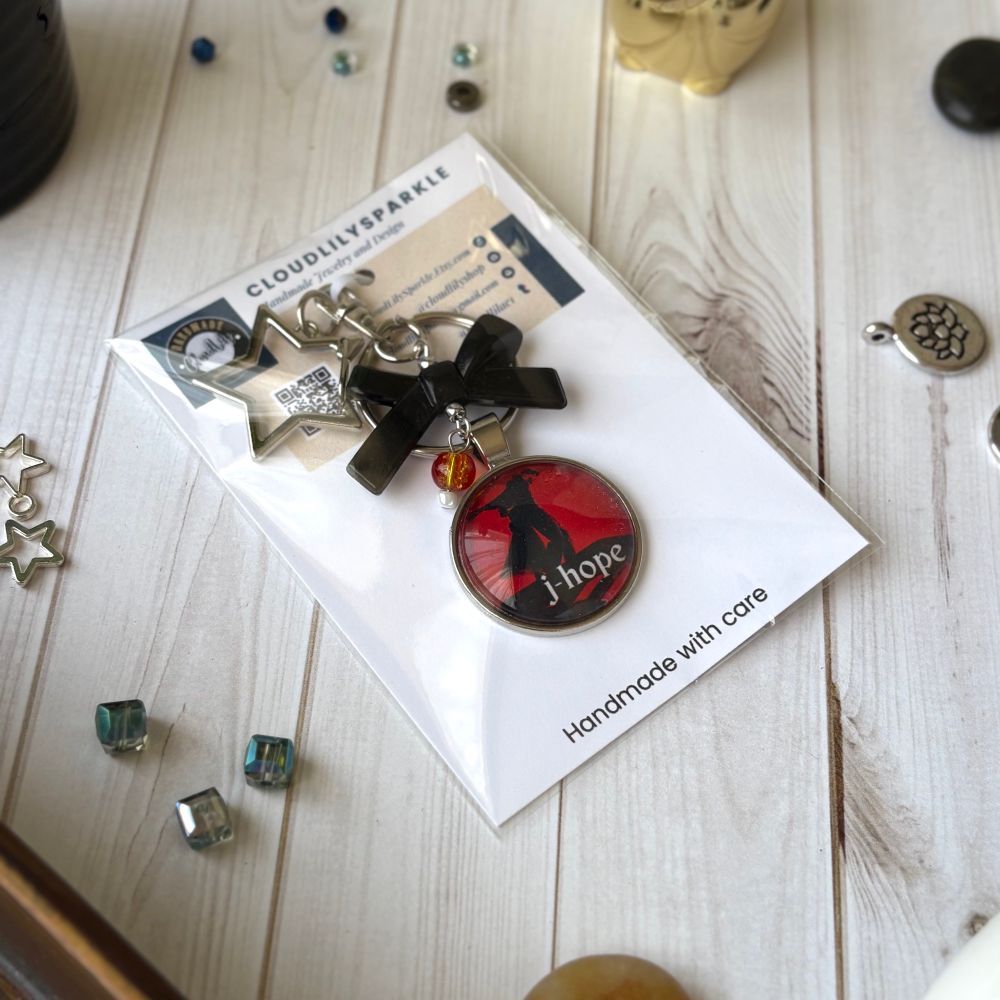 Handmades keychains by CloudLily. Printed artwork and designs in resin  sealed glass domes. Available at CloudLilySparkle.Etsy.com