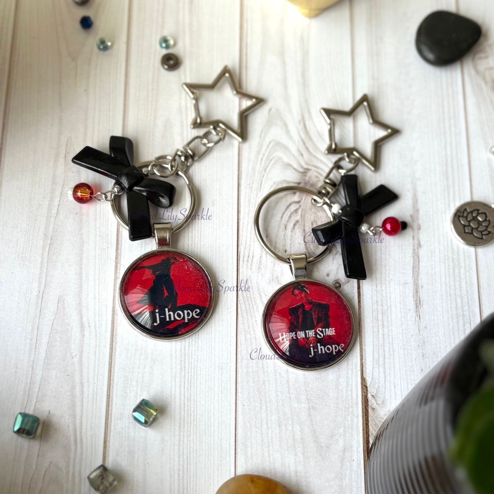 Handmades keychains by CloudLily. Printed artwork and designs in resin  sealed glass domes. Available at CloudLilySparkle.Etsy.com