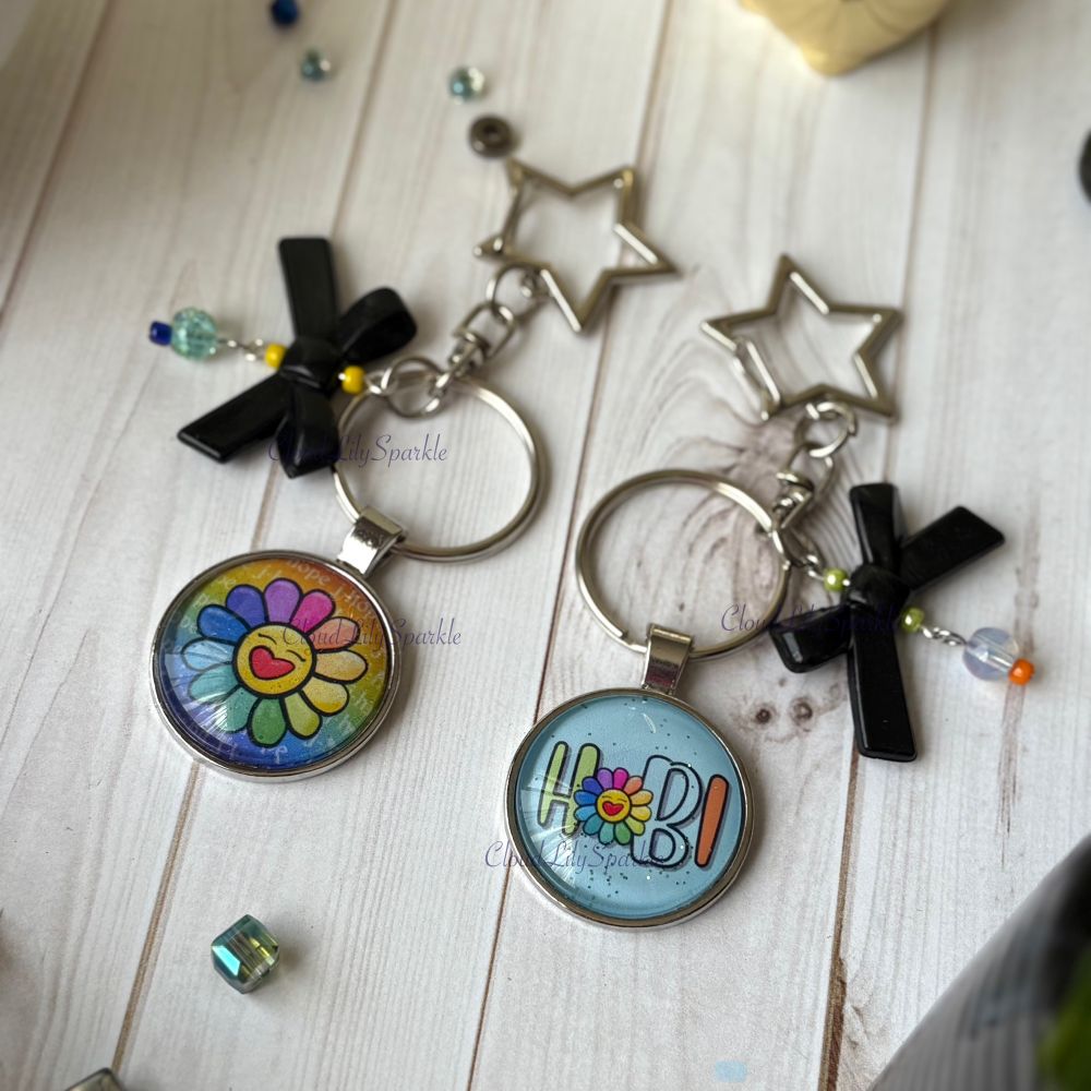 Handmades keychains by CloudLily. Printed artwork and designs in resin  sealed glass domes. Available at CloudLilySparkle.Etsy.com
