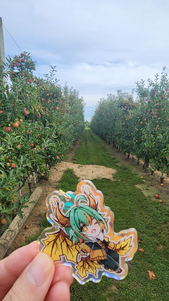 Aki in front of a row of apples