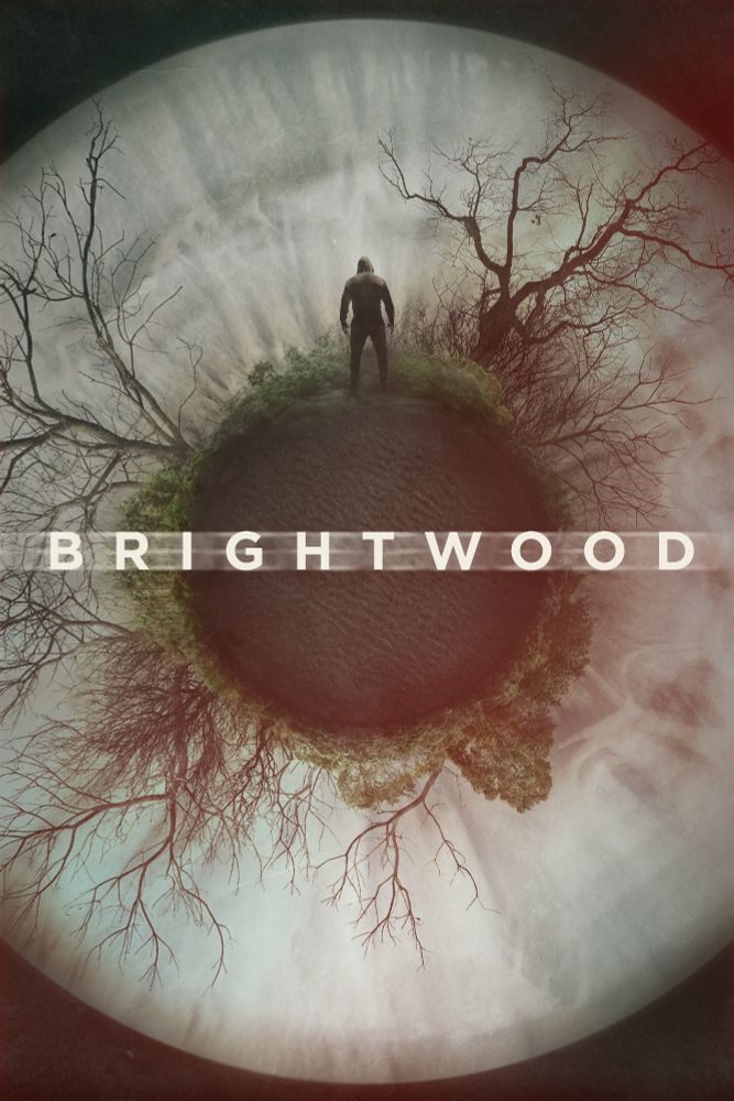 Movie poster for Brightwood, depicting a circular wrap-around of some trees in a circle. In the middle of the photo is a hooded man looking away from the camera.