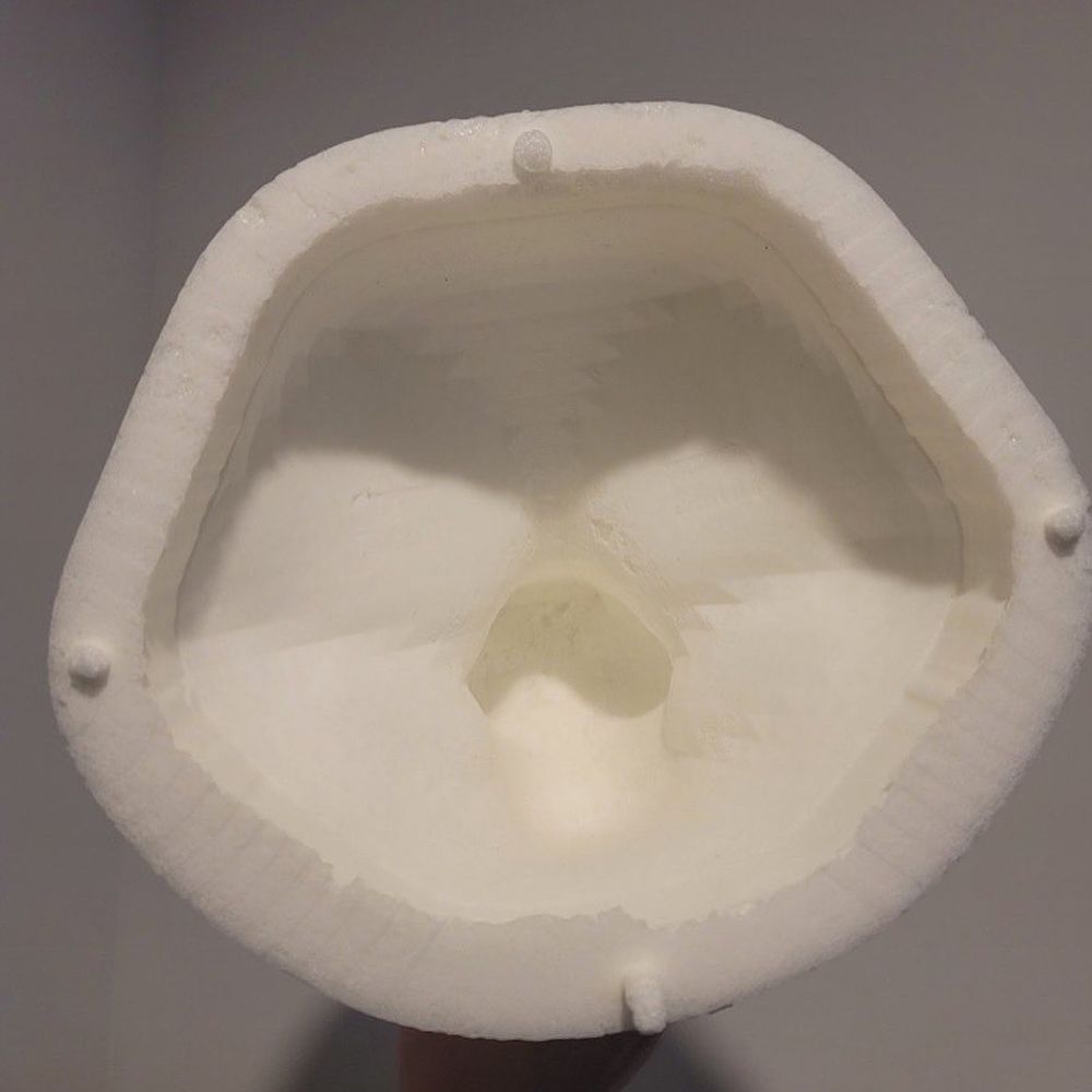 an image showing the back side of the head base, which is hollow, so there is no hand carving required to prepare the base for fur. 

