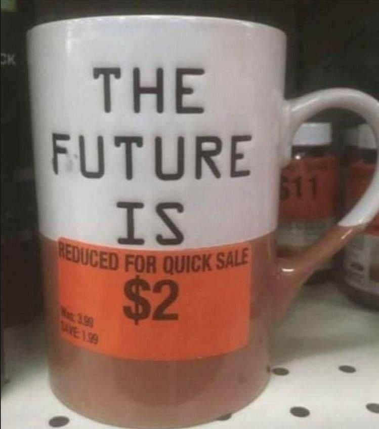Photo of a mug on a store shelf. The mug has a slogan, the bottom half of which is obscured by a sticker. The slogan and sticker together say "The future is / reduced for quick sale: $2"