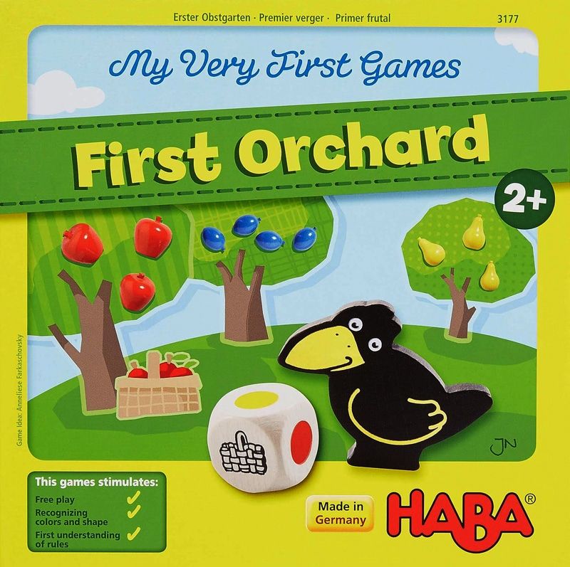 The cover of the children's board game "First Orchard", showing a black crow-like bird with a yellow beak.