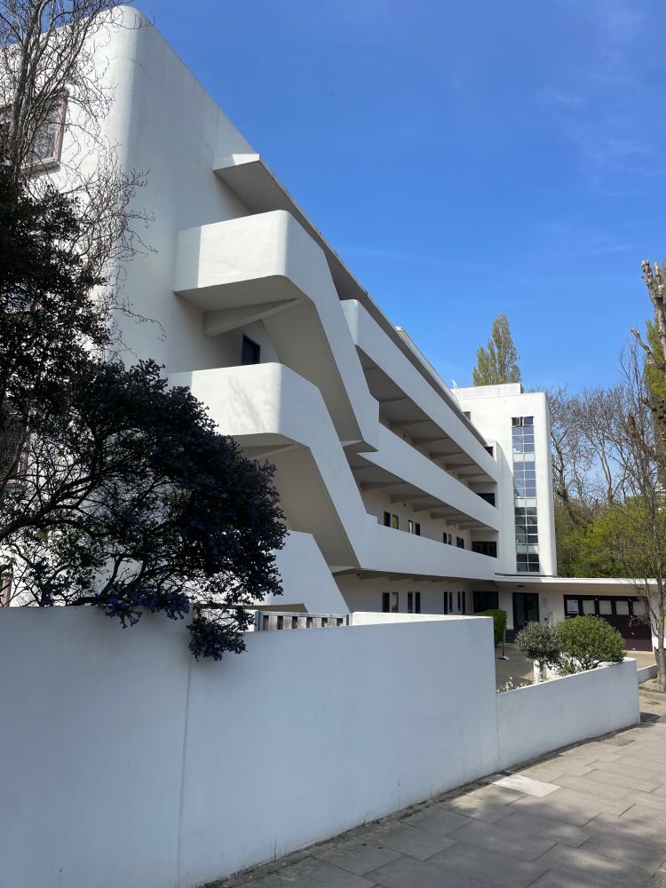 mid-rise white stucco block of 1930s flats.