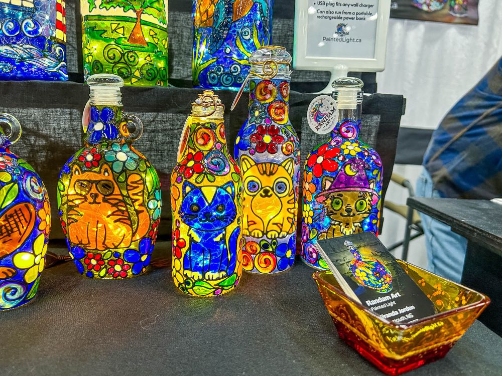 A rainbow of colour in a number of painted bottle lamps done by my friend Miranda of Paintedlight.ca, including a number with cats on them. They are beautiful and an excellent way to repurpose lovely bottles and keep them from the landfills. 