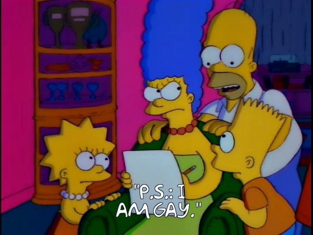 The Simpsons family (Lisa, Marge, Homer, and Bart). Marge is sat in a green armchair, writing a letter while the others are gathered around her. Homer has suggested "P.S.: I am Gay."