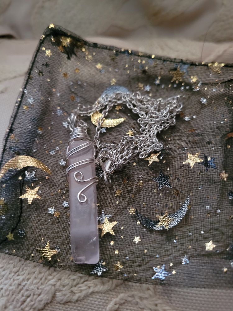 A necklace with a Crystal on it, representing my feminine side