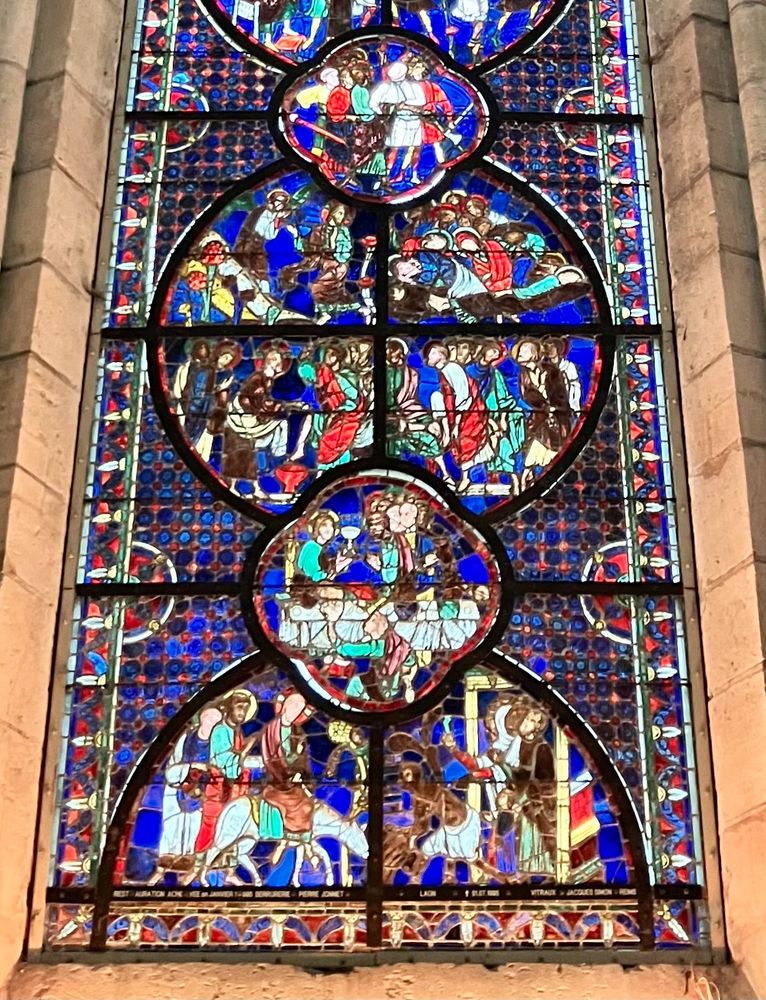 Detail from the bottom of the window showing Jesus entering Jerusalem, the last supper, and the betrayal in the the garden of Gethsemane