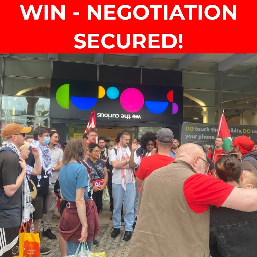 White text on red: "Win - Negotiation Secured!"

Under, image of ACORN members outside We The Curious holding banners