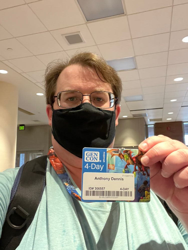 A selfie of me with my pass for GenCon 2025