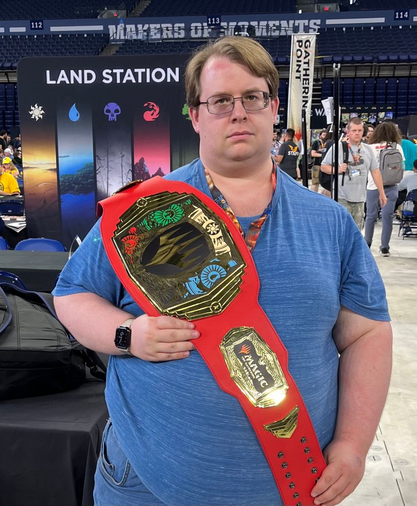 A picture of me holding a mock wrestling belt from the GenCon 2025 Prize Wall