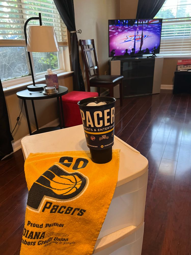 My seat in my house with a pacers cup and towel as game 7 starts