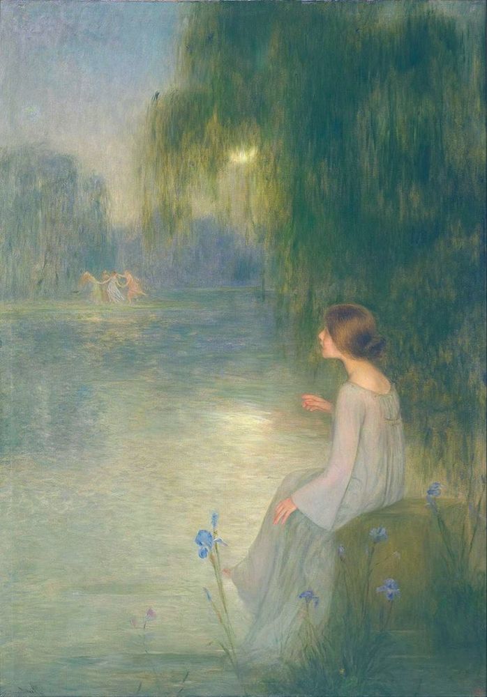A woman in a light, flowing gown sits on a rock by a tranquil body of water, viewed in profile. Her hair is styled in a bun, and she appears to be gazing across the water. 
The scene is set in a natural landscape featuring a calm lake or pond, with a weeping willow tree overhead. The moon shimmers through the foliage and reflects on the water's surface, creating a serene and ethereal atmosphere. 
In the misty distance across the water, a group of figures, likely identifiable as nymphs or women, are depicted joyfully dancing in a circle, contributing to the painting's dreamlike and symbolic quality. 
Delicate flowers, resembling irises, are visible in the foreground near the seated woman, adding a touch of natural beauty. 