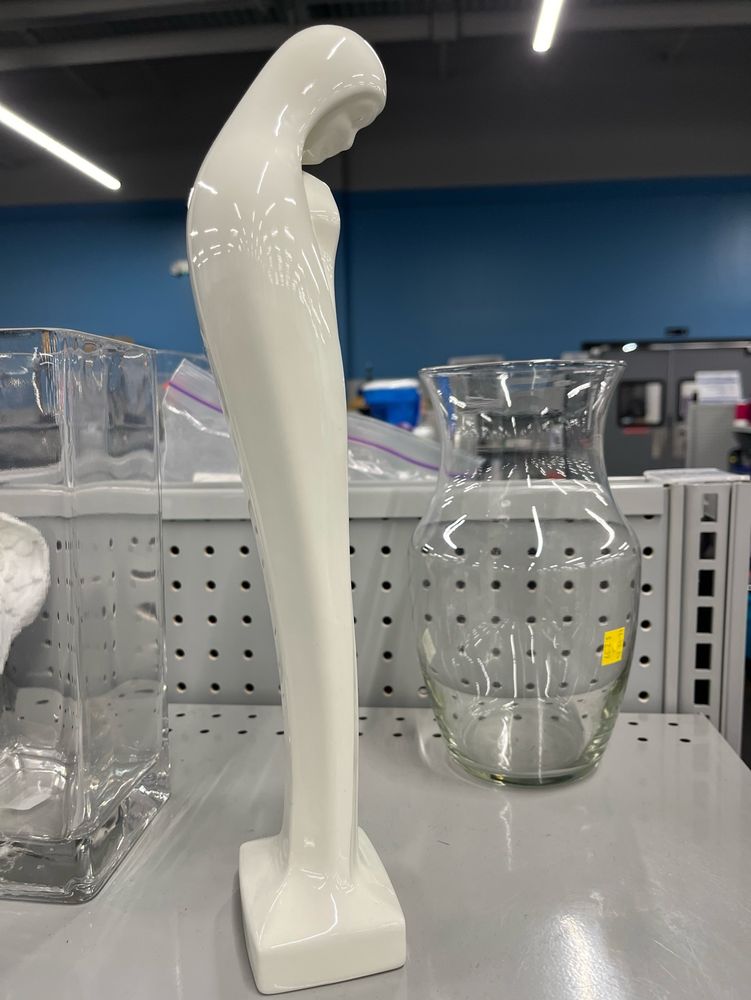 A religious statue of Mary that shows her shoulders slumped forward in a meek attitude of prayer. 