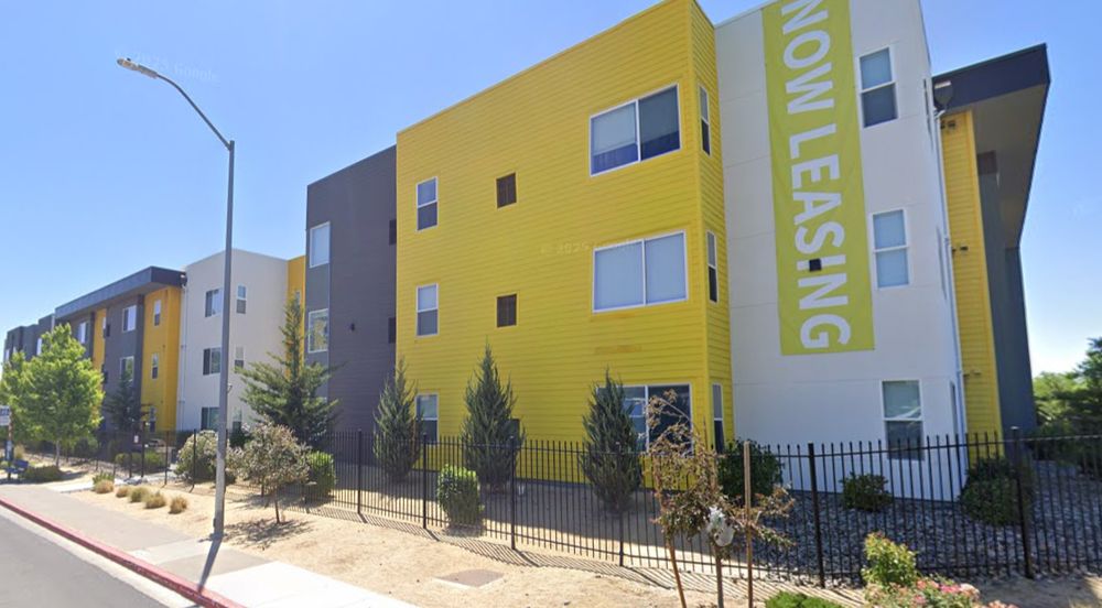 3-story boxes, offset forward and back by a few feet, with disparate colors and surface treatments, and flush mounted windows with no sills or lintels, let alone balconies