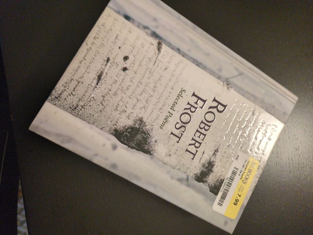 Used book of Robert Frost selected poems with a $7.99 half price books price tag in the corner