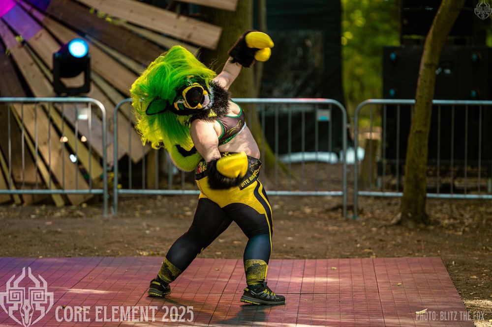 A fursuit dancer wearing Toxic mid performance. The hair is all swooshed up and around the head from the dance move. 