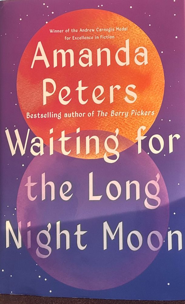 the book Waiting for A Long Night Moon. The cover is purple with stars in the background and two overlapping images of the moon, one orange and one purple at the center. 