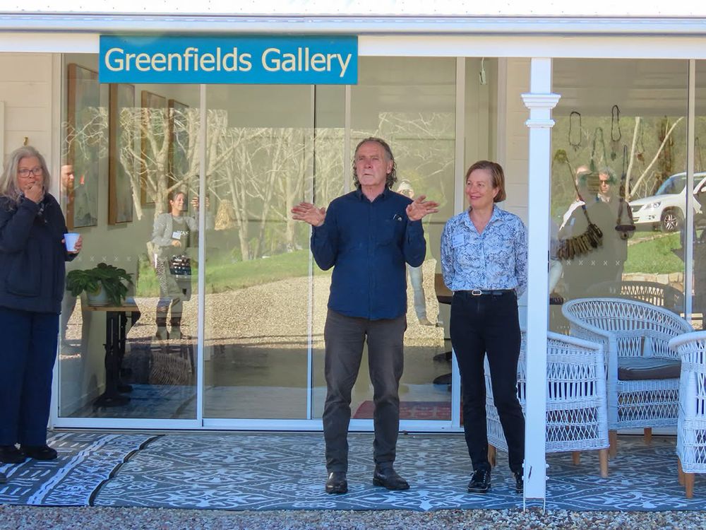 Curator, Kevin Wilson and Greenfields Gallery owner/artist, Robyn Glade-Wright standing side by side at the official opening of Coming Together: Right Here Right Now at Kin Kin in Queensland.