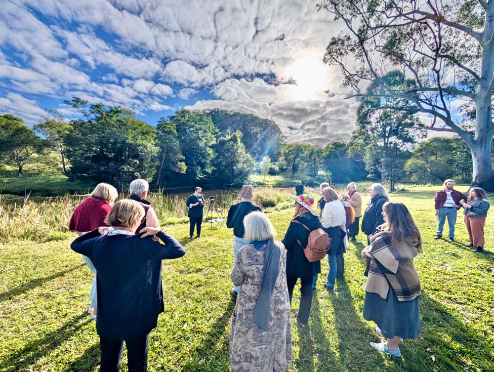 Me facilitating a ceremonial commemoration called ‘5 minutes of silence’ in memory of the species and ecosystems we’ve lost and are losing. About 15 people are gathered around me for this micro event.