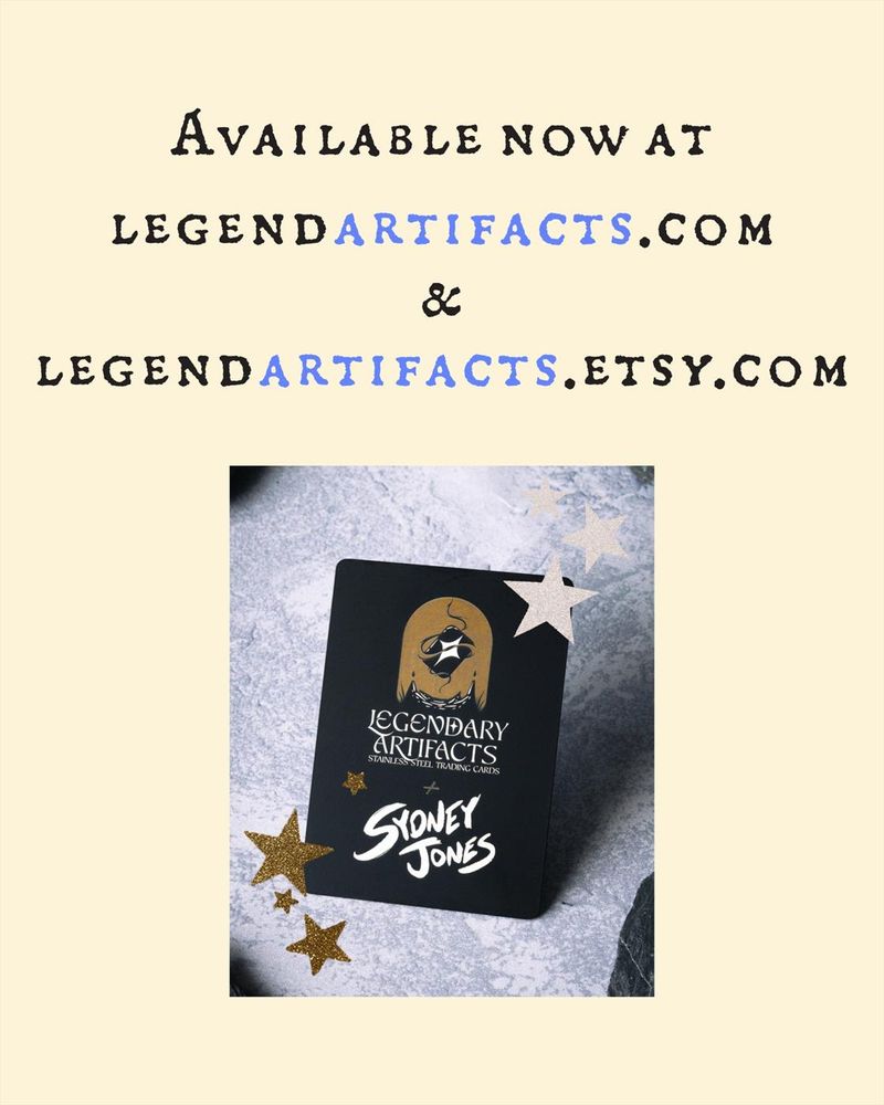 An image that shows the back of the hero token cards. The card has the Legendary Artifacts logo along with Sydney Jones', showing the collab. The image reads "Available now at legendartifacts.com & legendartifacts.etsy.com"