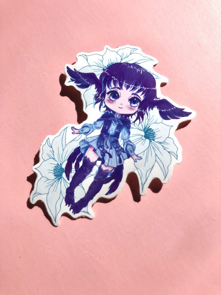A photo of an acrylic charm keychain featuring chibi art of Meteion from FFXIV, surrounded by Elpis Flowers.
