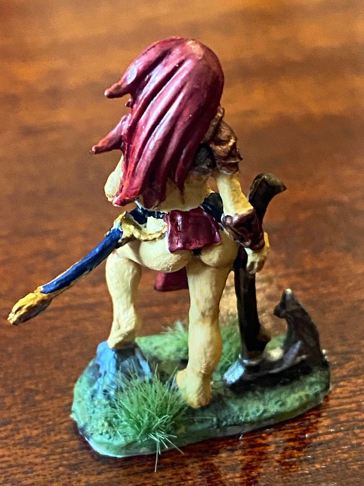 The rear angle of a red-haired warrior woman mini, still wearing very little!