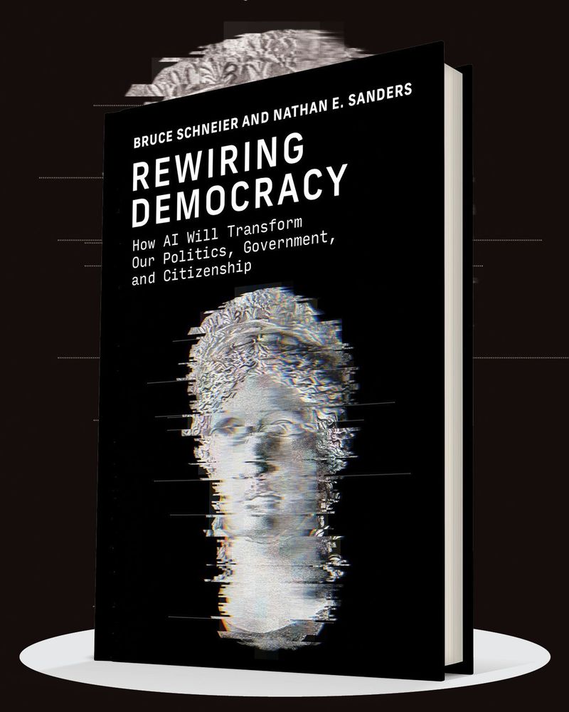 Cover of the book "Rewiring Democracy: How AI Will Transform Our Politics, Government, and Citizenship" by Bruce Schneier and Nathan E. Sanders. The design features a digital portrait of a face, partially disintegrating into pixels, set against a black background.