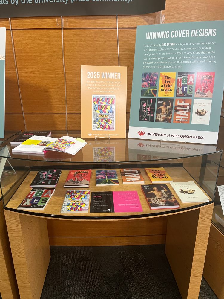 A close-up of one glass-table display showing winners from the University of Wisconsin Press