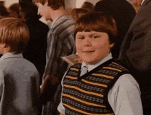 Diary of a Wimpy Kid gif where the kid waves happily and then gets unhappy very suddenly. 