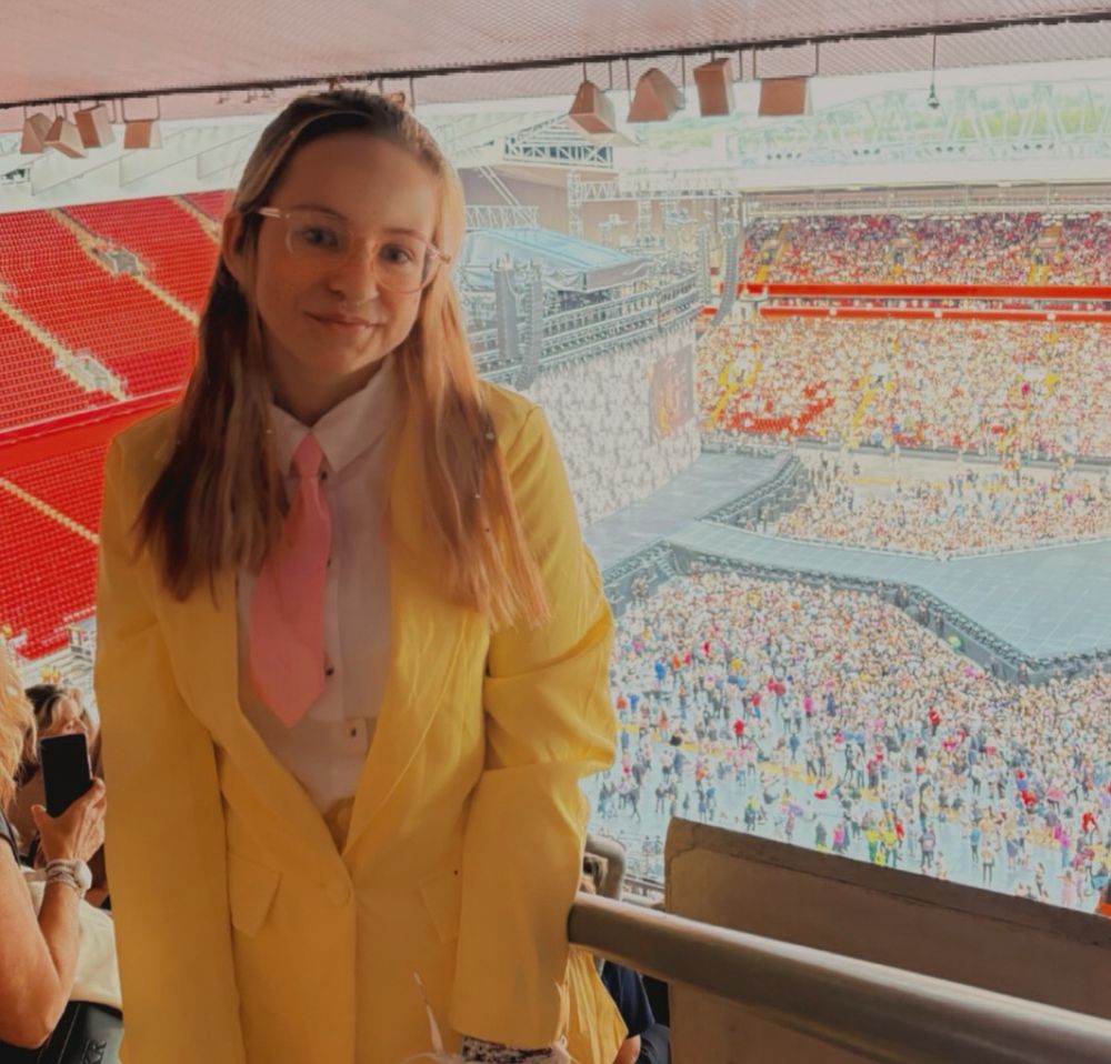Me in a Yellow me! Suit and pink tie. replica of the me! Suit in the music video and era tour in the background with fans 