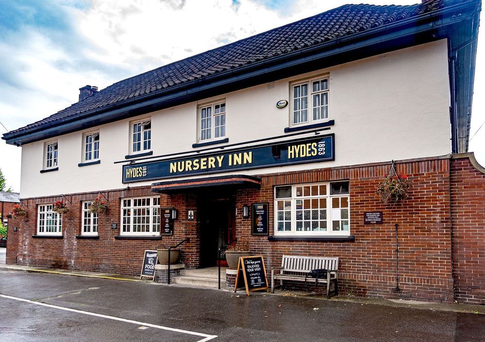 Red brick lower and white painted upper frontage of the Nursery Inn.