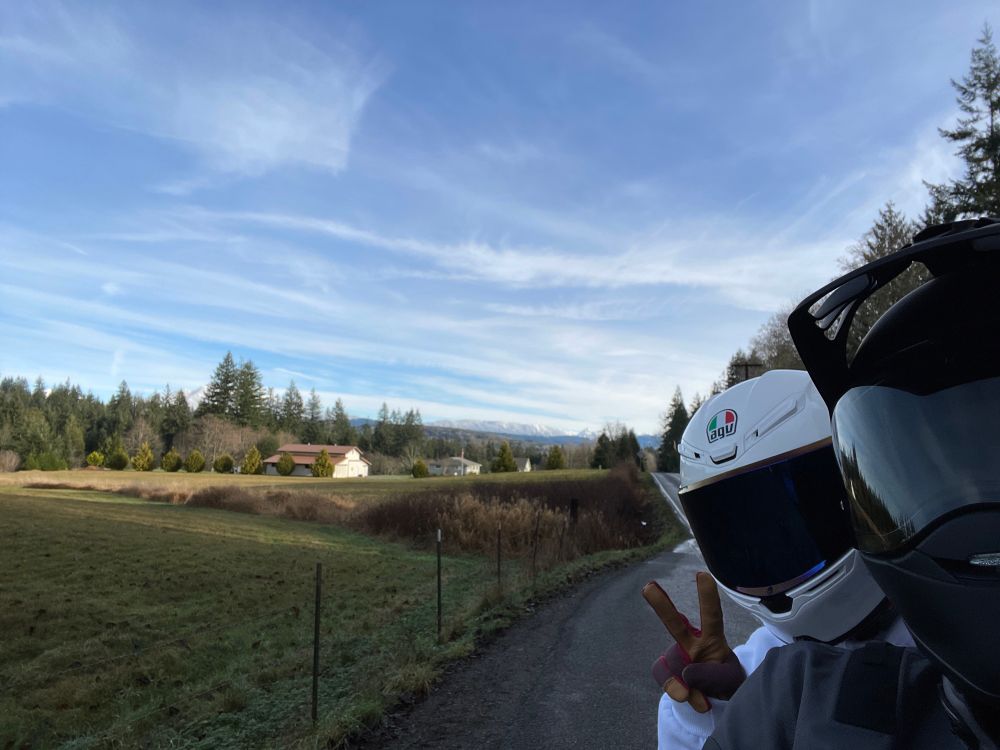 My partner and I with our helmets on and the snowy cascades in the background 