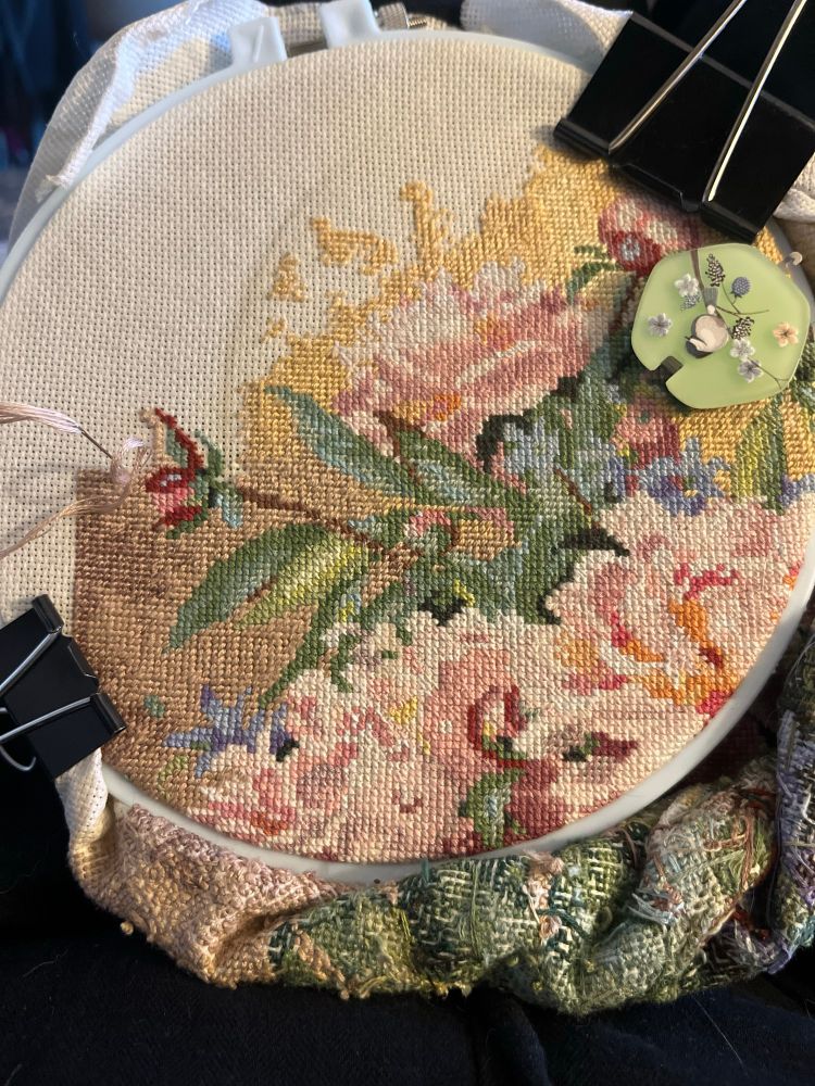top corner of a big cross stitch and peonies are done and it’s just background now 