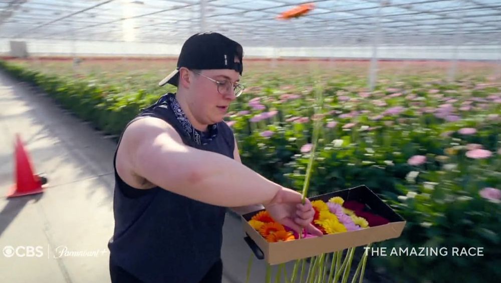 Izzy with flowers in the most recent promo for the amazing race 38
