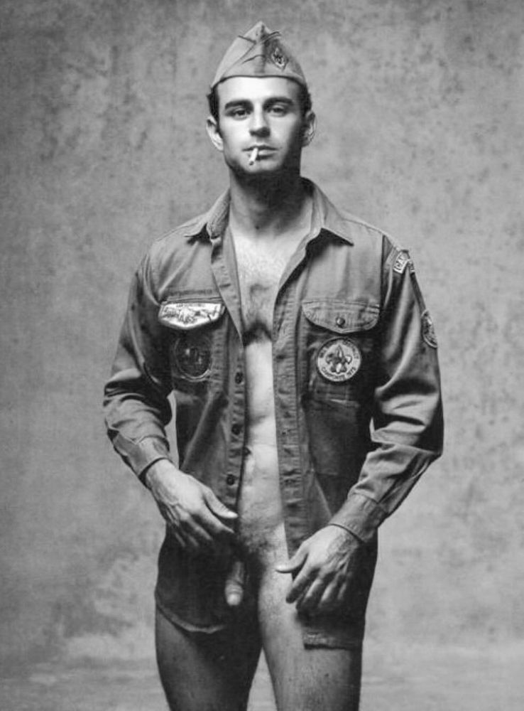 Vintage image of a serviceman in an unbuttoned shirt and wearing a cap. No undergarments, soft cock visible 