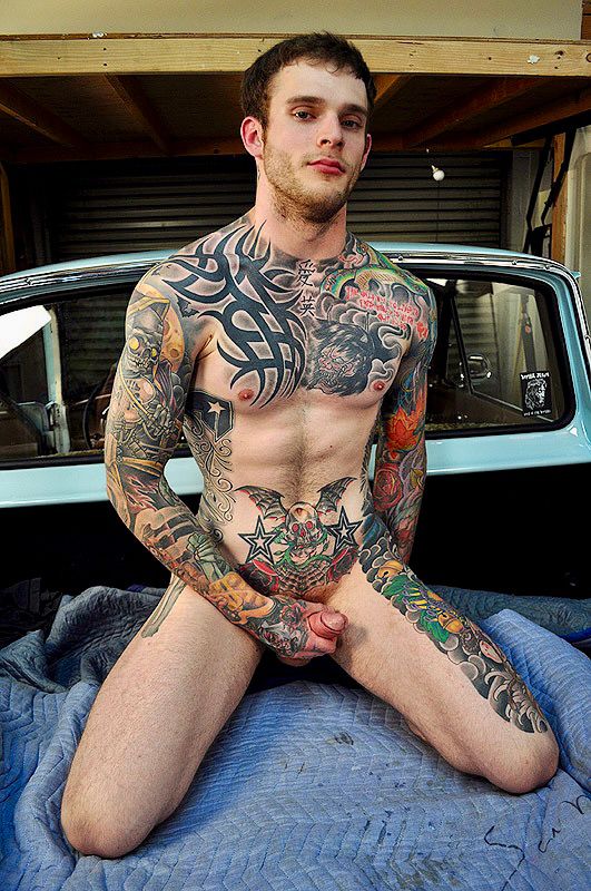 Young naked tattooed guy masturbates in the back of a pickup truck 