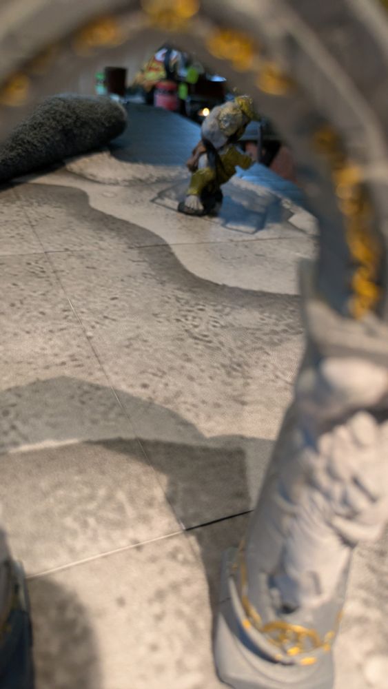 A giant miniature visible through a gate.