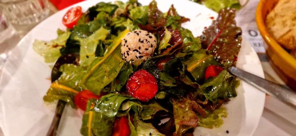 A leaf salad with strawberries and tomatoes