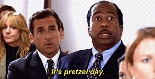 A person in a suit from the tv show "The Office" stating with a serious face: "It's pretzel day."