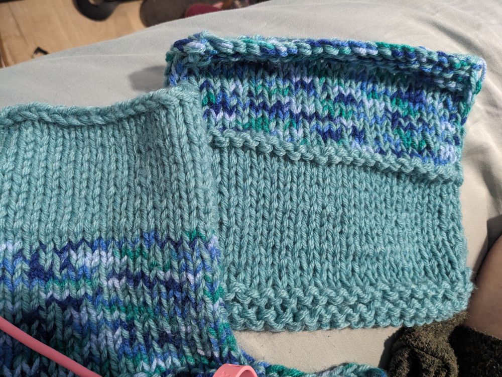 Two knitting swatches with different gauges in aqua and variegated blue yarns