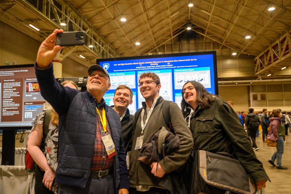 A group of students taking photos with AMS Past President Rich Clark at the 105th Annual Meeting.